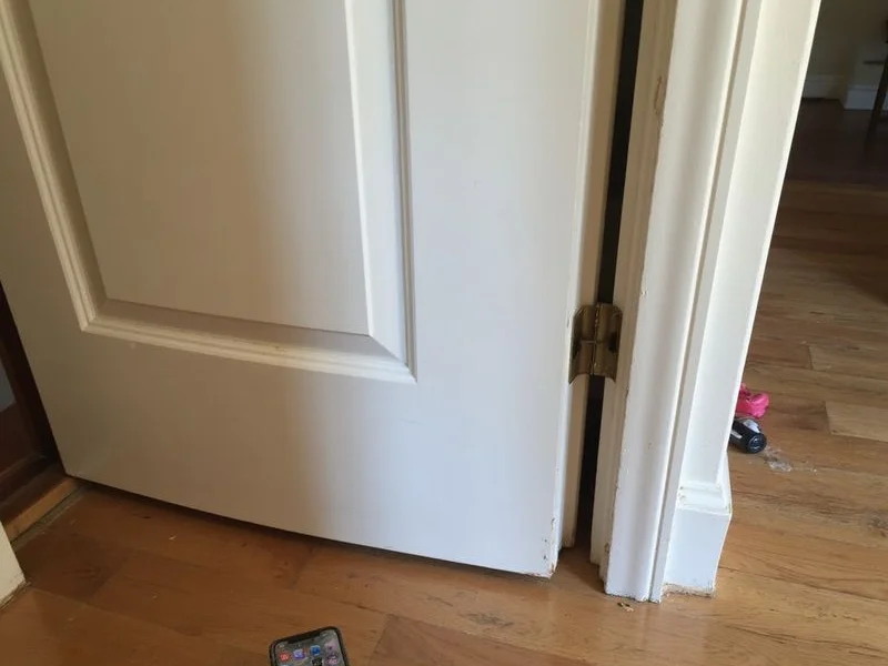Interior door closing cleanly in its frame after a completed leveling adjustment